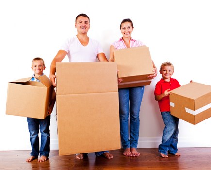 House movers loading furniture near a Kentish Town terraced home