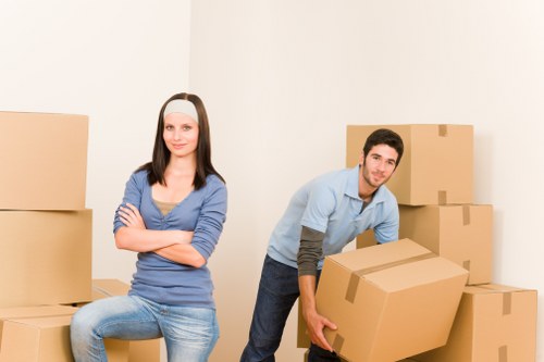 Staff using lifting equipment and protective gear during removals